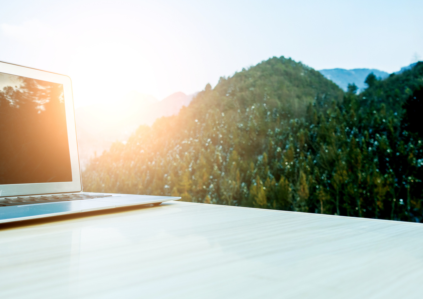 Laptop on desk with mountain